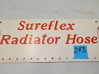 243 - SUREFLEXS RADIATOR HOSE MASONITE SIGN, 7" X 24"